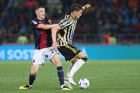 Michel Aebischer and Federico Chiesa battle for the ball